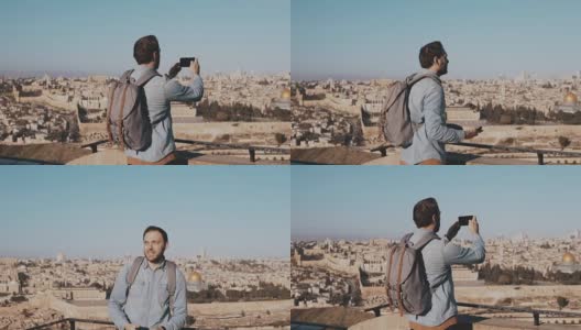 一名男性游客用智能手机拍摄耶路撒冷。欧洲大胡子男子欣赏古镇风光。以色列。慢动作高清在线视频素材下载