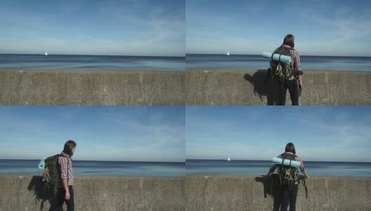 背包男徒步者在海边徒步4K高清在线视频素材下载