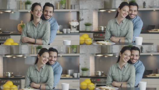 厨房里一对微笑的英俊夫妇的肖像。高清在线视频素材下载