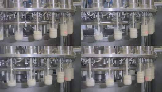 牛奶生产工厂用工业设备将牛奶倒入瓶中高清在线视频素材下载