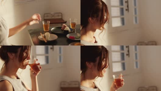 一个年轻女子在家里喝茶的特写高清在线视频素材下载