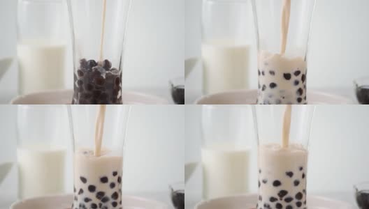 将奶茶倒入饮用杯中，加入台湾流行的珍珠泡。高清在线视频素材下载