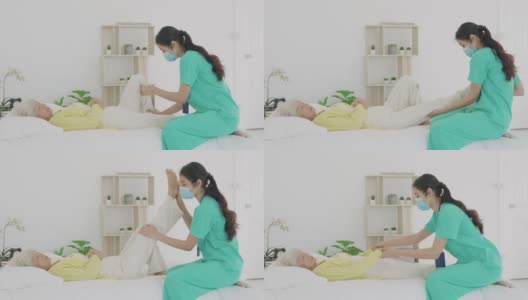 亚洲老年妇女在她的膝盖关节炎接受关节炎物理治疗康复专业护士或家庭健康助理在卧室在家。高清在线视频素材下载