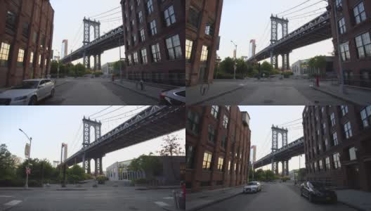 慢镜头:从小飞象那里看布鲁克林大桥，小飞象的公寓和路边停着的汽车在夏天的清晨与跑步者擦肩而过高清在线视频素材下载