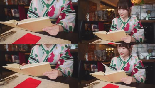 年轻女子在浴田读书在法国餐厅高清在线视频素材下载