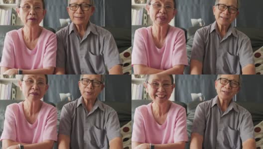 亚洲老夫妇和他们的孩子微笑着对着镜头说话。老年人学习使用智能手机app和互联网在线技术进行远程会议。高清在线视频素材下载