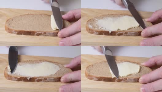 特写:用刀在面包上抹黄油高清在线视频素材下载