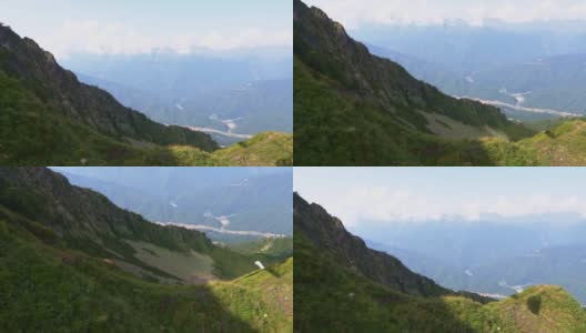 在夏天攀登高山，从山顶欣赏草地和田野的风景，徒步旅行和冒险旅行高清在线视频素材下载