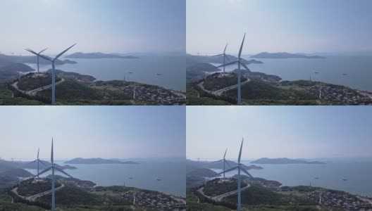在海边的山顶上风力涡轮机的鸟瞰图高清在线视频素材下载