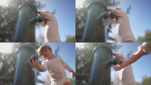 小朋友在公园的公用水龙头取水。喷泉的水高清在线视频素材下载