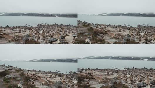 挪威。美丽的奥特伦湖海岸的石头在春天多云的日子。挪威自然高清在线视频素材下载