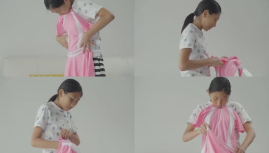 快乐亚洲女孩收到粉色泳衣从网上购物，生活理念。高清在线视频素材下载