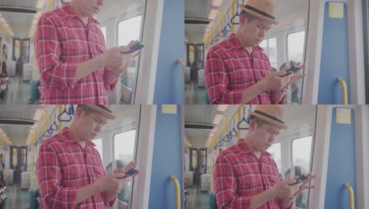 一名商人在去机场的火车上用手机查看电子邮件。高清在线视频素材下载