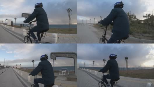 男孩骑着自行车在日落前进来。高清在线视频素材下载