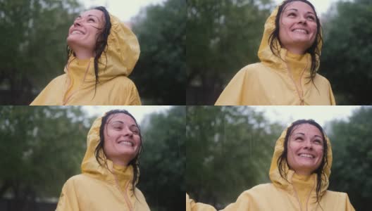快乐的女人在雨中微笑。爱、自然、幸福、自由的概念。高清在线视频素材下载