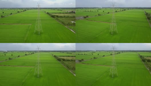 无人机在绿色农场的塔-电塔周围飞行高清在线视频素材下载