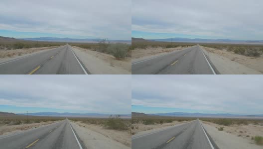 在沙漠山谷的空旷道路上驾驶拍摄，4K慢镜头高清在线视频素材下载