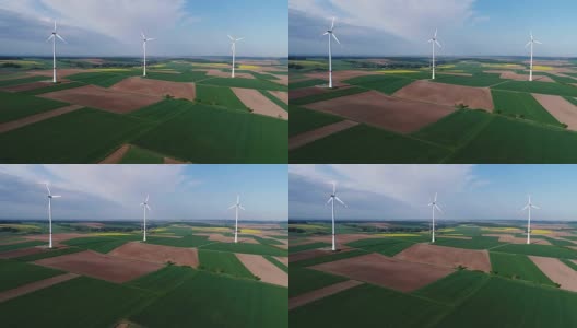 风电场站在绿色的田野上，风力发电机的背景是蓝天和浮云，晴天，全景，空中，四旋翼，欧洲，德国，巴伐利亚高清在线视频素材下载