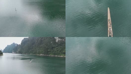 木筏漂浮在湖中的4k鸟瞰图。高清在线视频素材下载