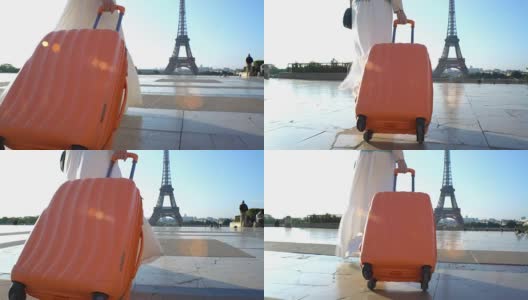 拿着橙色手提箱的女人去巴黎旅行高清在线视频素材下载