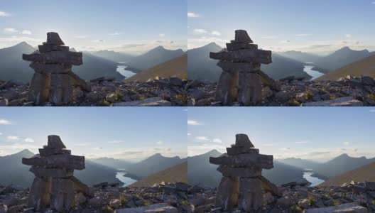 2.5D视差视频岩石人inukshuk在山顶上俯瞰日落湖高清在线视频素材下载