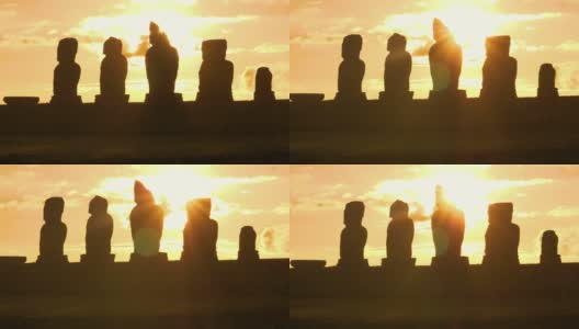 太阳耀斑:金色的夕阳照亮了复活节岛上的一排摩埃石像。高清在线视频素材下载