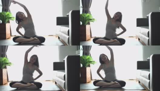 怀孕的亚洲母亲在客厅练瑜伽高清在线视频素材下载