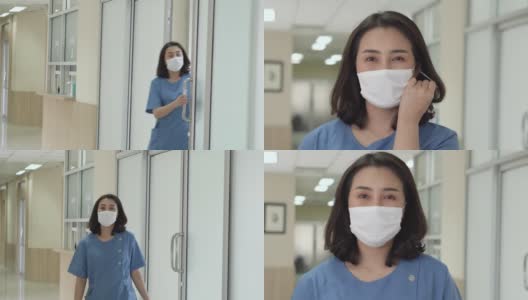一个自信的女医生的肖像行走和打开防护面具和微笑。高清在线视频素材下载