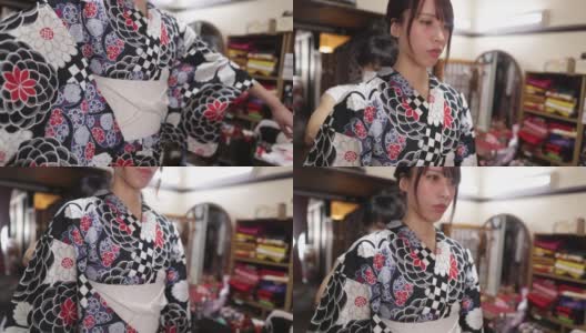 在出租和服商店里，一位日本妇女正在系宽腰带高清在线视频素材下载