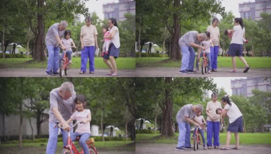 亚洲的祖父母教孙子骑自行车，与家人一起散步和锻炼高清在线视频素材下载