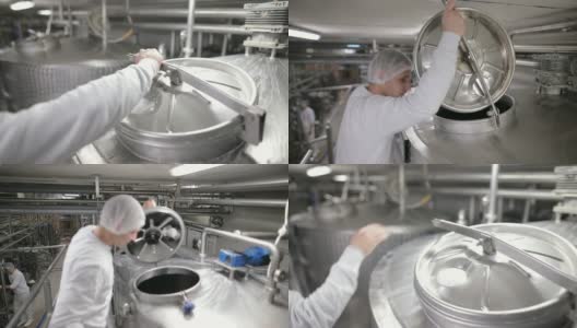 食品厂的工人打开巴氏杀菌罐。乳制品高清在线视频素材下载