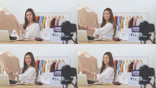 美丽的亚洲女人博客展示购物衣服和连衣裙。在摄像机前录制在家的视频直播。商业在线影响者对社交媒体的概念。高清在线视频素材下载