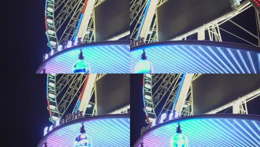 在闪闪发光的大轮入口，巴黎路的标牌上有不断变化的灯光高清在线视频素材下载