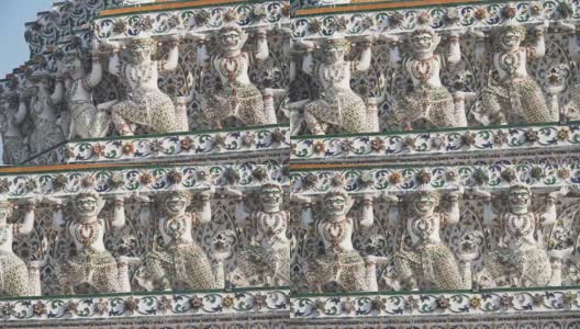 手持式低角度视角:泰国风格的雕像，作为巨大的是在Wat Arun大宝塔下高清在线视频素材下载