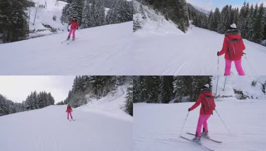 女子滑雪者在滑雪路线下，在松林中山坡高清在线视频素材下载