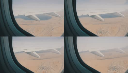 飞机正在沙漠上空飞行。一架飞机在沙漠的黄色背景下飞出窗外高清在线视频素材下载