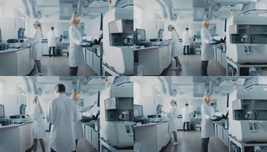 研究团队的科学家在计算机上工作，与医疗设备，分析血液和遗传物质样本的特殊机器在现代实验室。高清在线视频素材下载