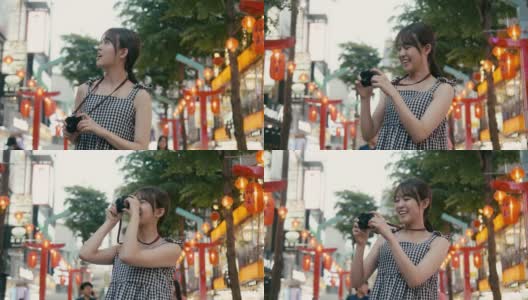 台湾的视频博主在西门的大街上走来走去，用老式相机拍照(慢动作)高清在线视频素材下载