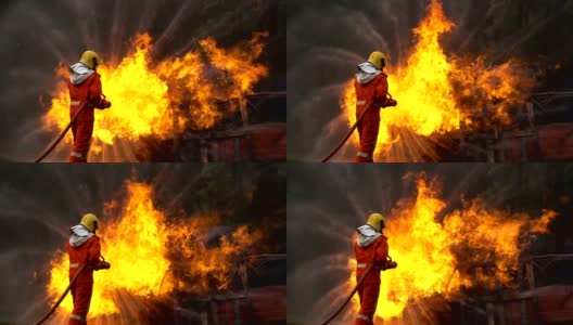一名勇敢的消防队员用螺旋形水龙带扑灭一场车祸中的大火的慢镜头高清在线视频素材下载