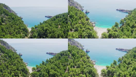 阳光明媚的鸟瞰图树梢和田园诗般的绿松石海，加尔加诺国家公园，意大利高清在线视频素材下载