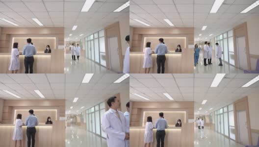 4K宽镜头的大堂等候区在现代化的医院或医疗设施，病人在询问柜台和一组专业医生和护士在医疗中心的卫生服务。高清在线视频素材下载