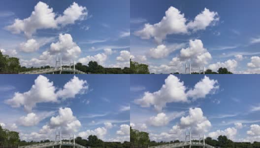 湛蓝的天空和湖上的桥，人们在夏天玩独木舟高清在线视频素材下载