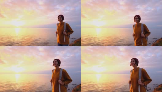美丽自由狂野的女人，夕阳下的天空是大海高清在线视频素材下载