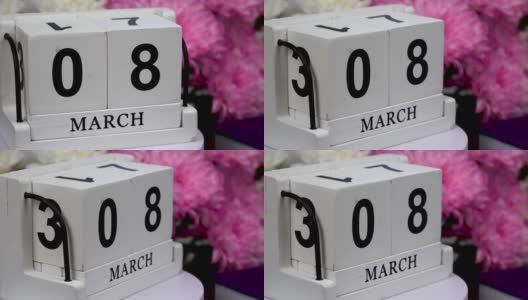 桌面日历上有3月8日的日期和一束美丽的鲜花。三八娇嫩菊花。手工木方与日期，月和日。为一天做计划。高清在线视频素材下载