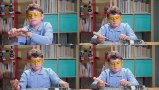 儿童在保护眼镜上用烙铁焊接印刷电路板高清在线视频素材下载