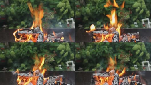 燃烧的木材烧烤在自然背景的郊区地区。火中的余烬。在篝火中燃烧着煤。高清在线视频素材下载