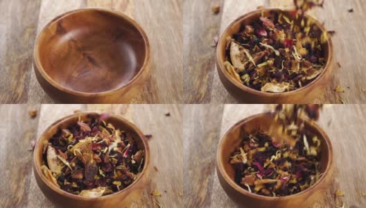 有机草本水果花茶木质表面。将干燥的药草、花瓣和碎片放入一个质朴的木碗中高清在线视频素材下载