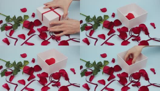 情人节快乐。礼物。红玫瑰花瓣和红丝带。礼物高清在线视频素材下载
