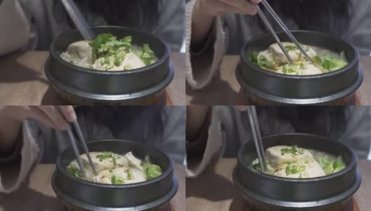 在中国餐馆吃豆腐火锅。高清在线视频素材下载