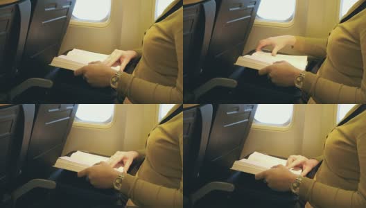 一个女人在飞机上看书的4K视频高清在线视频素材下载